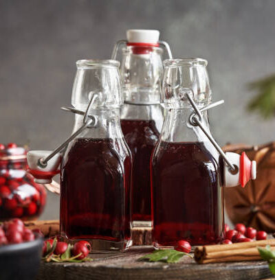 Bottles of homemade medicinal wine made of fresh wild hawthorn berries