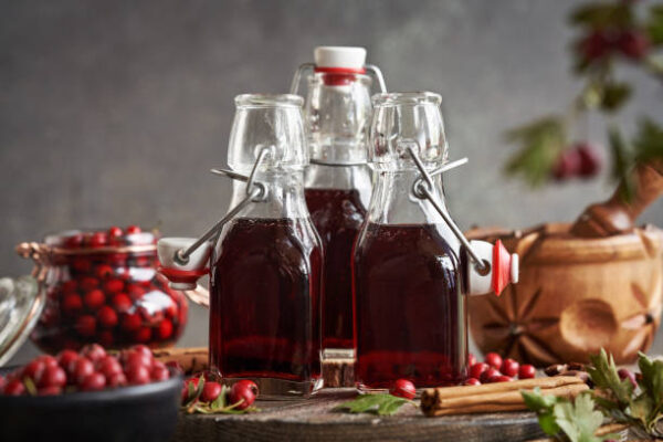 Bottles of homemade medicinal wine made of fresh wild hawthorn berries