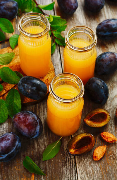 Fresh plum juice on the wooden table